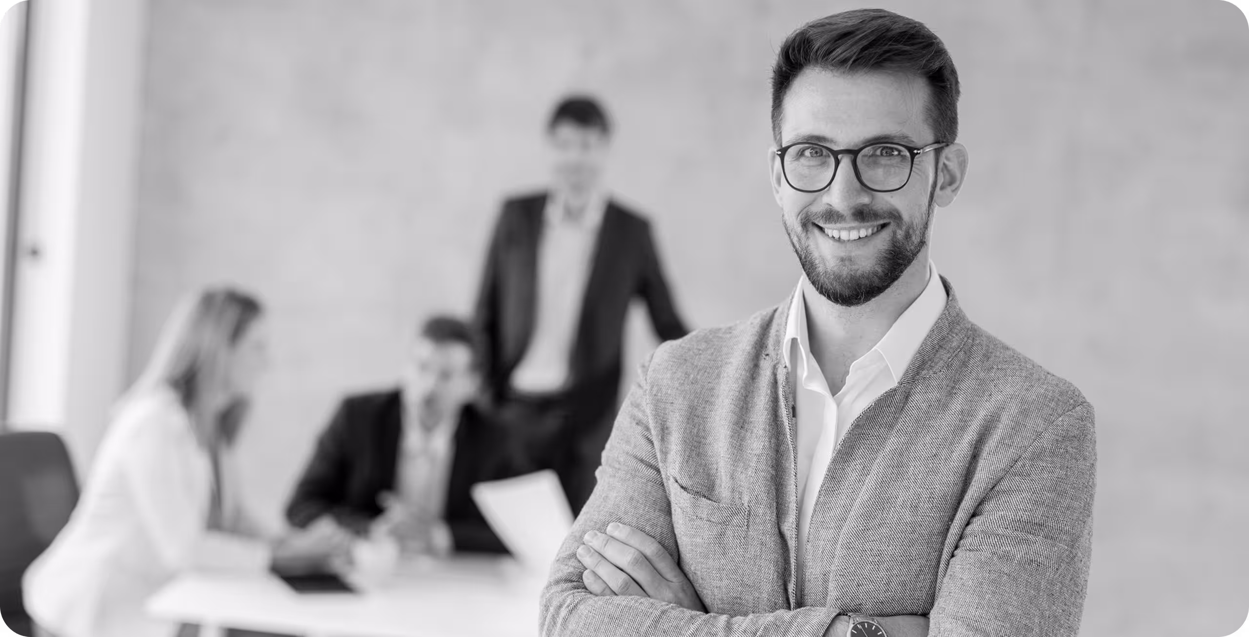 a man with glasses and a beard smiling